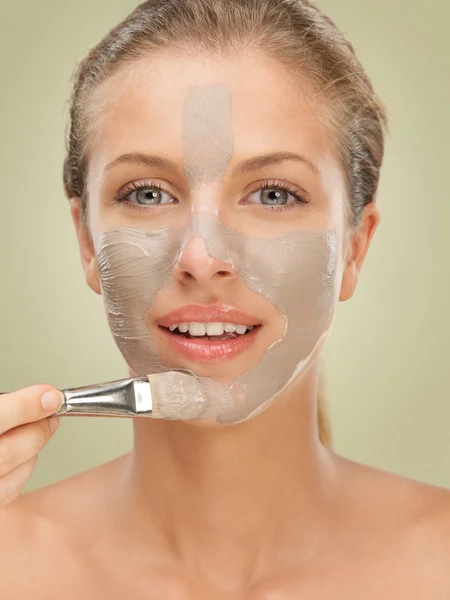 Closeup beauty portrait woman applying facial mask