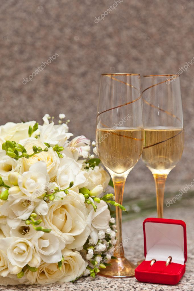 Wedding bouquet rings and champagne