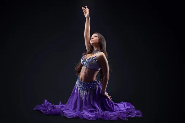 Arabia dancer posing in dark - oriental costume