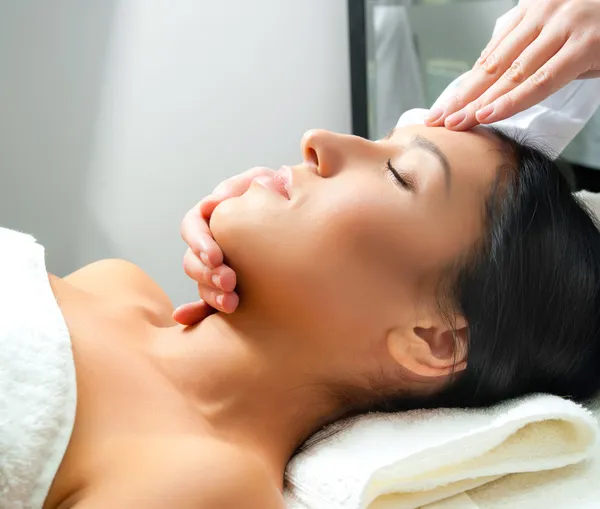 Woman receiving facial massage