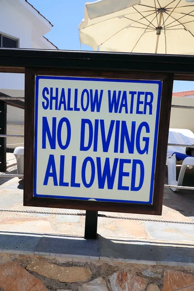 Warning sign near swiming pool \