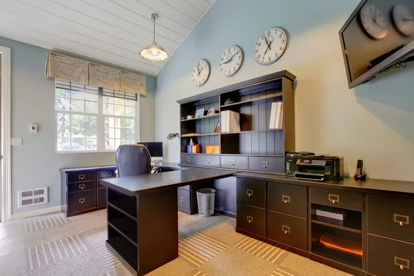 Blue modern home office interior design with dark brown furniture.