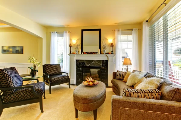 Living room in golden yellow wth fireplace and mirror