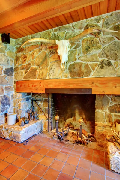 Stone large fireplace with wood ceiling and metal