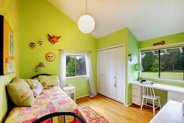 Green kids, girls bedroom.with white furniture.
