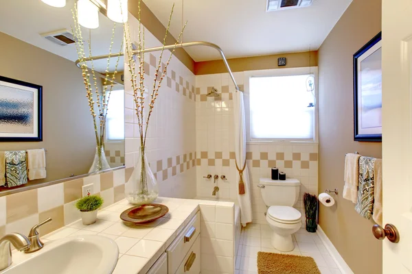 Bathroom with beige and white tiles interior.
