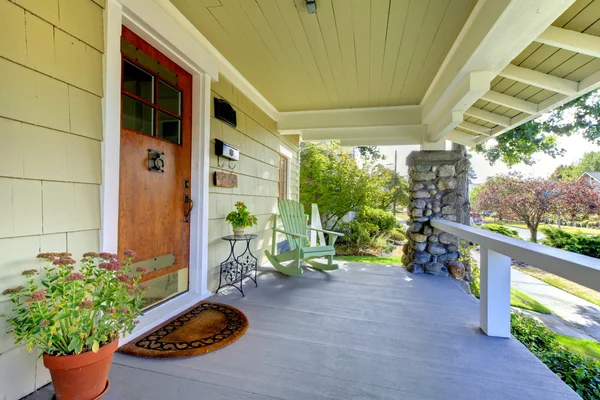 Covered front porch of theold craftsman style home.