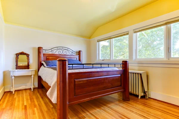 Bedroom with ots of windows and wood floor.