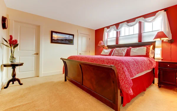 Master red romantic bedroom with beige carpet.