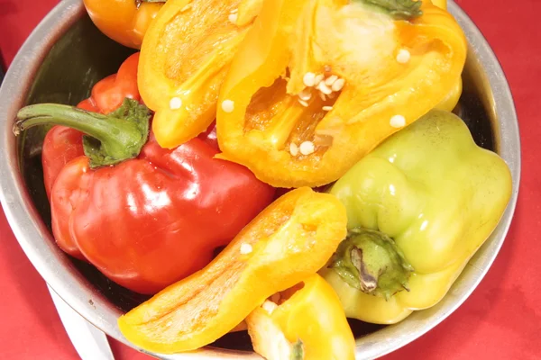Red, yellow, orange peppers on a plate