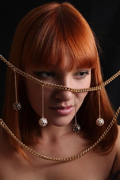 The red-haired girl and gold jewelry