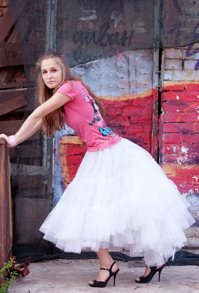 Girl in white skirt and pink T-shirt