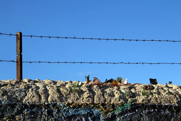 Old wall with barbed wire and crystals