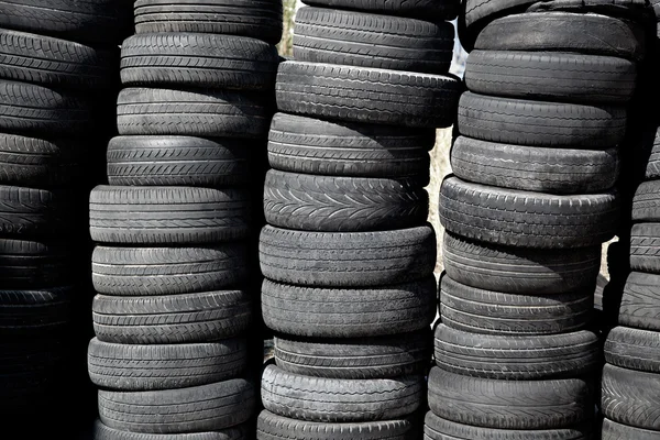 Car tires pneus stacked in rows