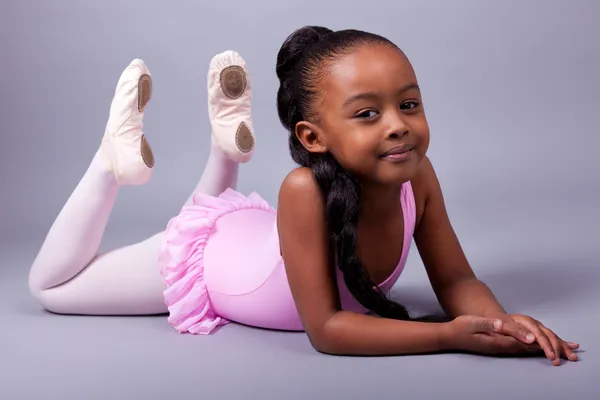Cute little African American girl wearing a ballet costume