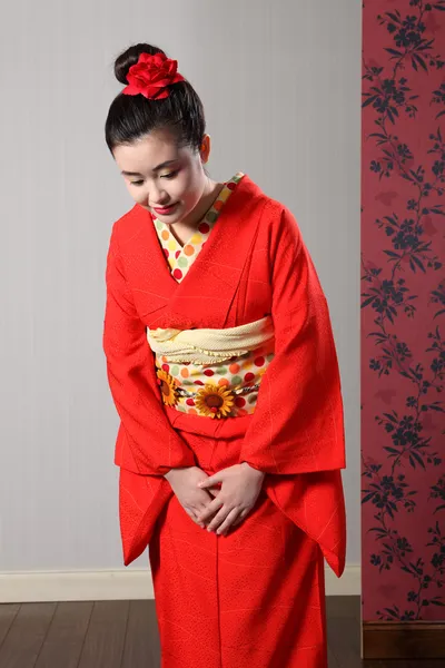 Bowing respect by Asian woman in Japanese kimono