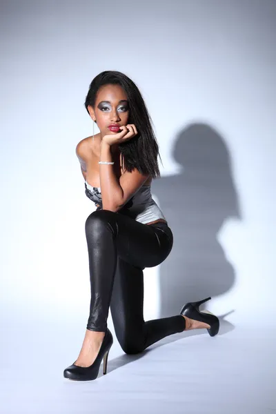 African american woman in leggings and stilettos