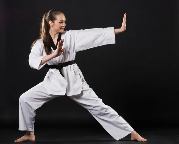 Girl in kimono exercising karate kata