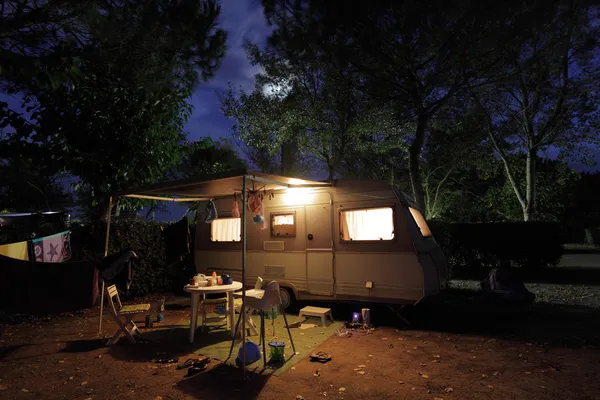 European mobile home on a camping site at night.