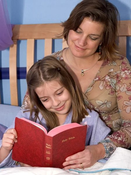 A mother and daughter reading bedtime stories together