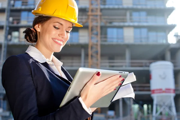 Attractive female construction specialist with a tablet computer