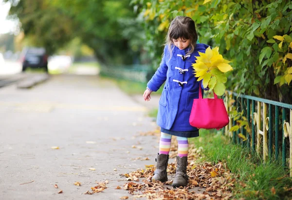 Funky little child girl in autumn atmosphere
