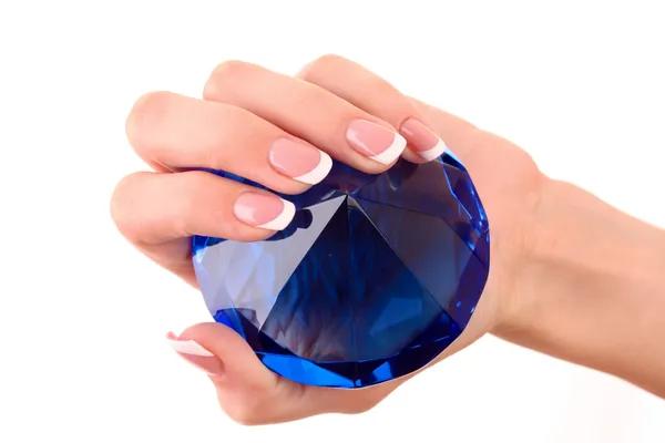 Giant blue diamond in hand isolated on white
