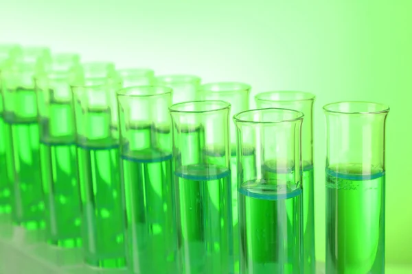 Test-tubes on green background
