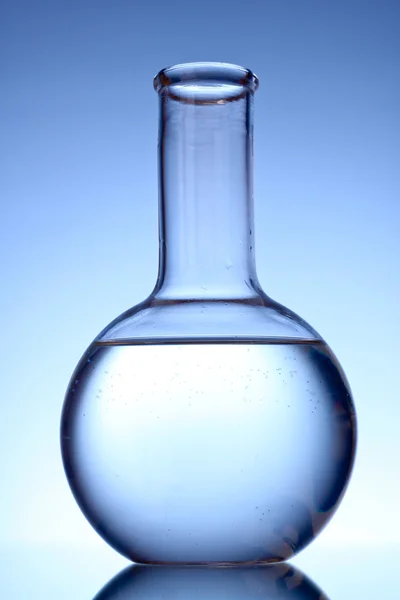 Flask with liquid on blue background