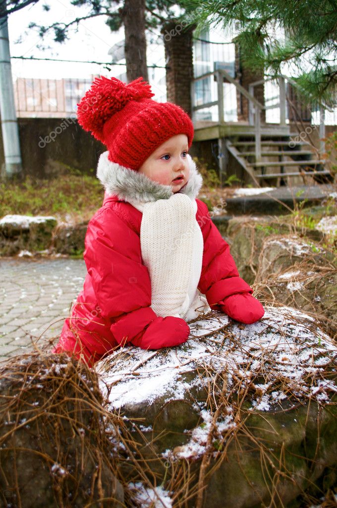 Adorable baby girl in red snowsuit — Stock Photo © tkud 7310855