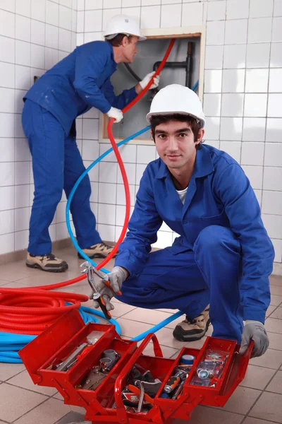 Plumber and apprentice