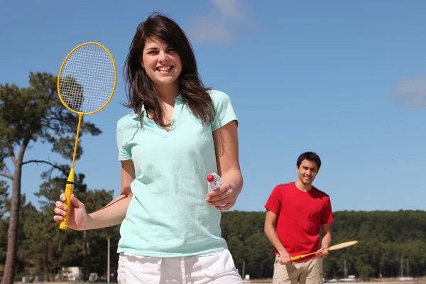 A couple playing badminton