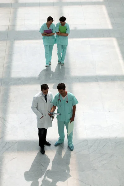 Hospital staff walking down corridor