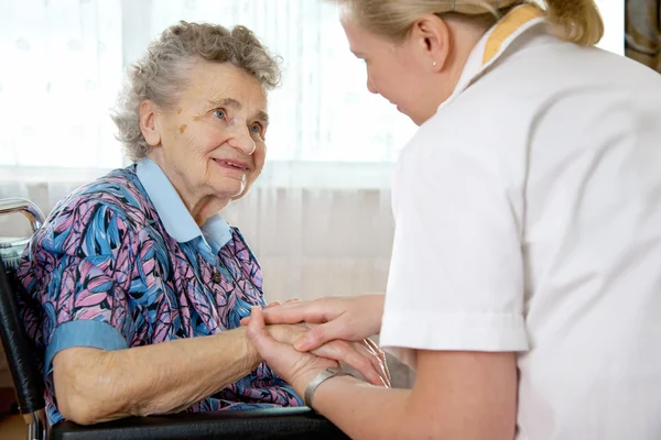 Senior woman with her home caregiver
