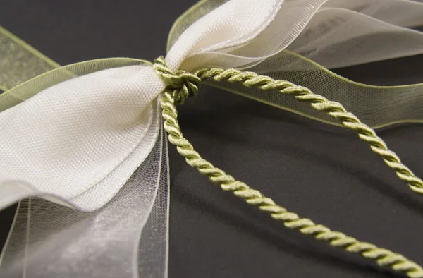 Decorative white and green bow