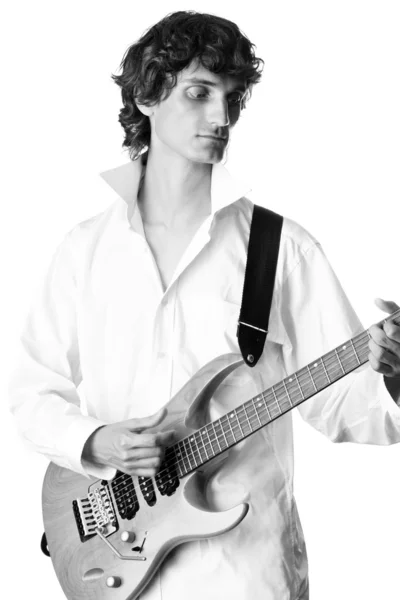 Young man in white shirt playing electric guitar