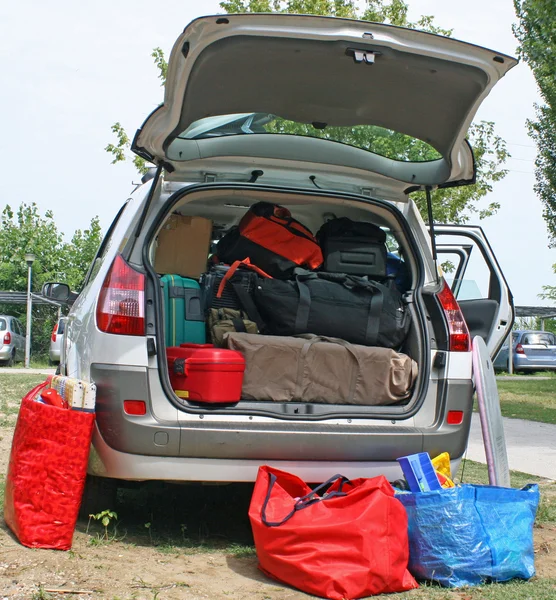 Family car with suitcases and bags to return from vacation