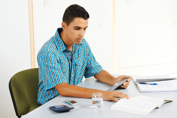 Young man studying with a tablet PC