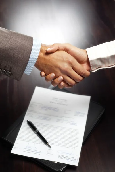 Handshake above signed contract
