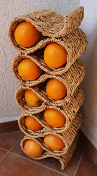 Oranges in a stand for the wine bottles in the corner.