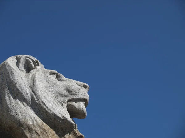 Lion statue on blue sky