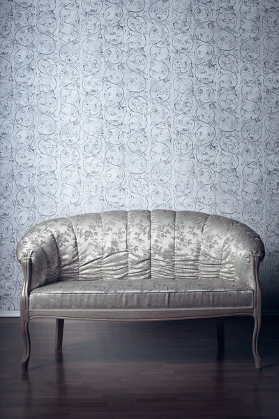 Glamorous sofa in the background of vintage wallpaper