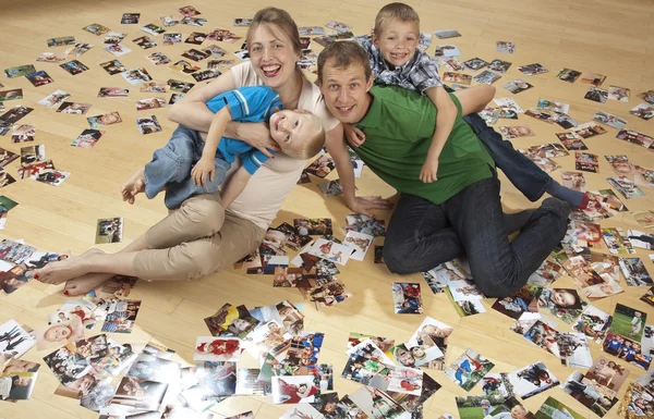 Family having fun on the floor and watching photos