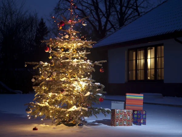 Christmas Tree with home outside with gift boxes