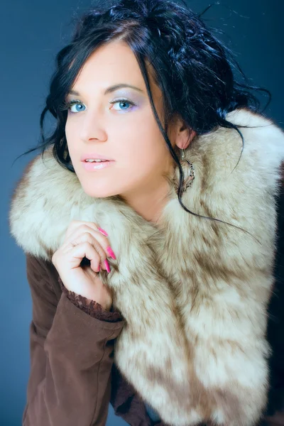 Portrait of attractive, dark hair girl, female model in fur