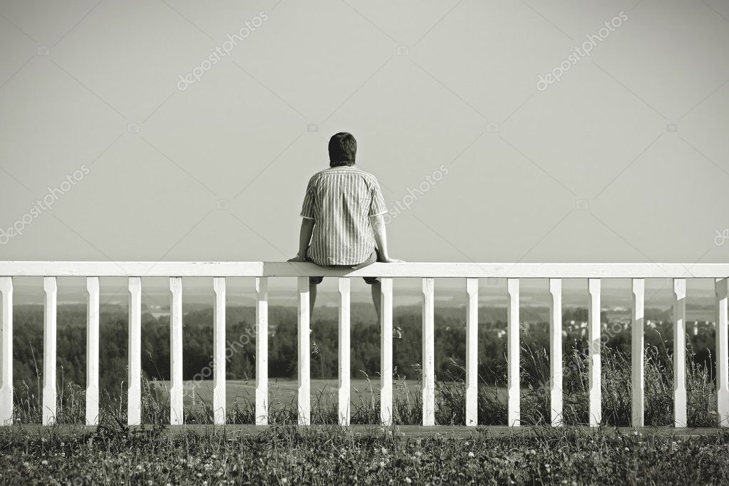 depositphotos_7864119-Man-sitting-on-a-fence-facing-the-landscape.jpg