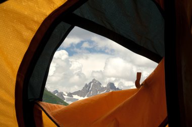 View from tent on mountains clipart