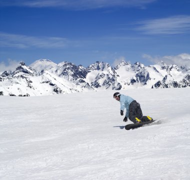 Snowboarder descends a slope clipart