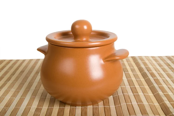 Clay pot on the striped mat — Stock Photo, Image