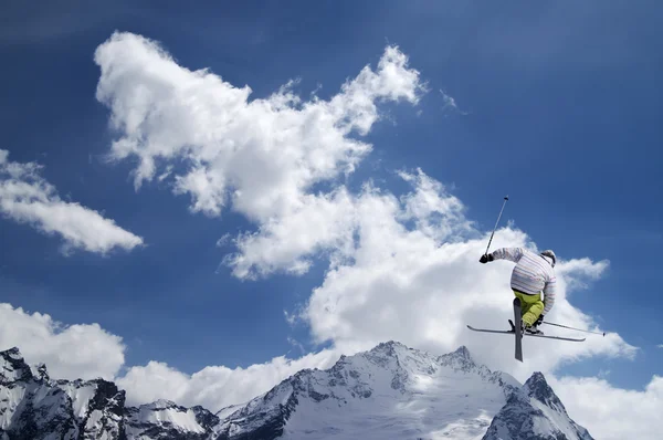 Freestyle ski jumper with crossed skis — Stock Photo, Image